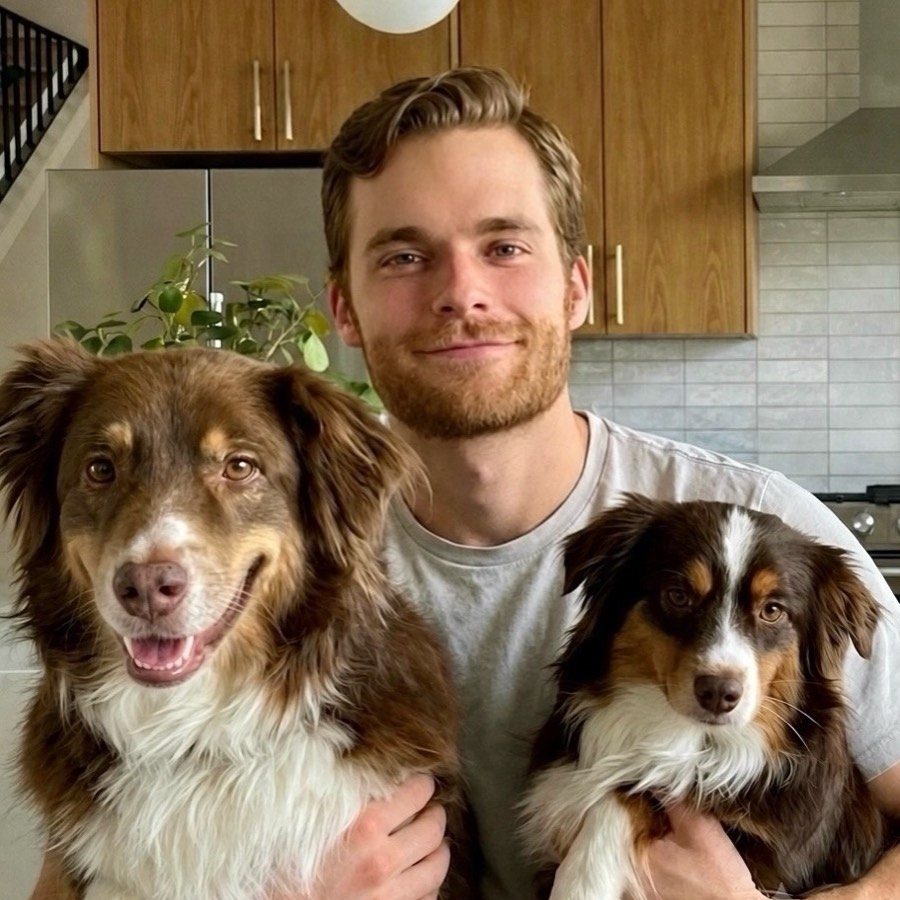 Wesley Donald at home in Austin with his two Australian shepherds